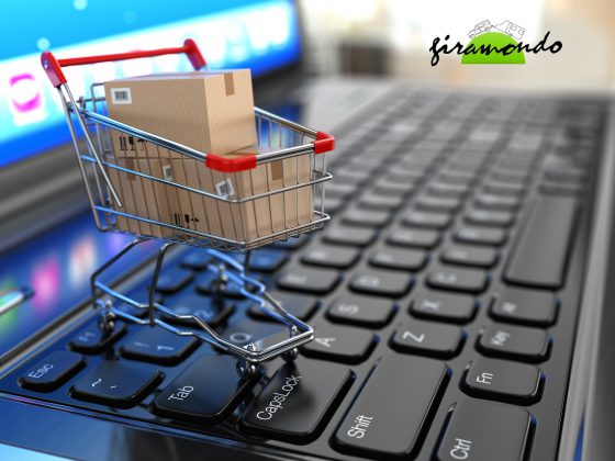 E-commerce. Shopping cart with cardboard boxes on laptop. 3d